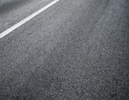 Detail of asphalt road with white line